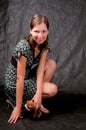 Dark haired tall girl sitting on knees Royalty Free Stock Photo