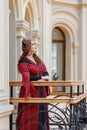 A dark-haired Tudor woman in a red dress Royalty Free Stock Photo