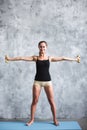 Dark-haired woman exercising with two dumbbells Royalty Free Stock Photo
