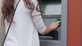 Dark-haired Young Woman In Front of ATM