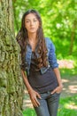 Dark-haired young woman leans on Royalty Free Stock Photo