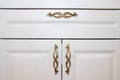 Dark handle on the white facade of the cabinet. Furniture fittings. Royalty Free Stock Photo