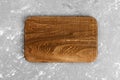 Dark handmade wooden cutting board on dark background. Top view