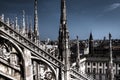 Dark HDR photo of the marble statues and decorations on the Cathedral Duomo di Milano on piazza in Milan and Royal Palace of Milan Royalty Free Stock Photo