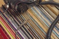 dark headphones lay on stack of retro vinyl records b