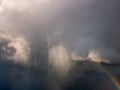 Dark heavy storm clouds with a rainbow on the edge Royalty Free Stock Photo