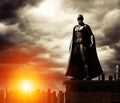 Dark Superhero on rooftop overlooking cityscape Royalty Free Stock Photo