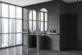 Dark home bathroom interior with double sink, shower and panoramic window