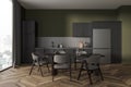 Dark home kitchen interior with cooking and dining area, panoramic window Royalty Free Stock Photo