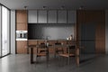 Dark home kitchen interior with eating and cooking space, panoramic window Royalty Free Stock Photo