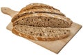 Dark Integral Multigrain Bread Loaf Sliced On Cutting Board Isolated on White Background Royalty Free Stock Photo