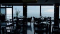 Dark interior in modern panoramic bar. Scenic ocean view in luxury lounge cafe Royalty Free Stock Photo