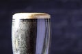 A dark Irish dry stout beer glass close up