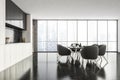 Dark kitchen interior with eating table and kitchen set near window Royalty Free Stock Photo