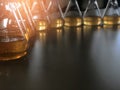 The dark laboratory room with the Erlenmeyer or Conical flask on bench laboratory, with gradient solvent for analysis total iron. Royalty Free Stock Photo