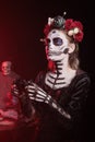 Dark lady playing videogames with controller during Dia de los Muertos Royalty Free Stock Photo