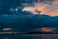 Dark landscape with blue clouds over the sea after sunset Royalty Free Stock Photo