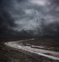 Dark Landscape with Dirty Road and Moody Sky Royalty Free Stock Photo