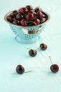 Dark lapin cherries vintage colander Royalty Free Stock Photo