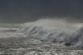 Dark long spraying sea wave