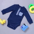 Dark and light blue onsie with toys Royalty Free Stock Photo