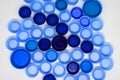 Dark and light blue plastic bottle caps on white background. Flat lay, view from above Royalty Free Stock Photo