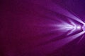 On a dark lilac structural fine-grained background, a light purple scattered beam of light