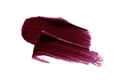 Dark lipstick smear smudge swatch. Plum color cosmetic product brush stroke isolated on white background