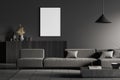 Dark living room interior with empty white framed mockup poster on wall, sofa, table, commode, concrete floor. Concept of Royalty Free Stock Photo