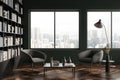 Dark living room interior with two armchairs, bookshelf and window Royalty Free Stock Photo