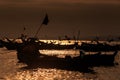 Dark Boat Silhouettes against Sunset Reflection on Ocean Water Royalty Free Stock Photo