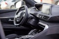 Dark luxury car interior. Black leather multifunctional steering wheel, start and stop engine buttom, dashboard