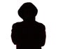 Dark male silhouette in casual sportswear with a hood, figure of a guy hiding his face, concept of privacy and confidentiality