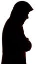 Dark male silhouette in casual sportswear with a hood, figure of a guy hiding his face, concept of privacy and confidentiality