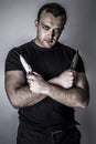 Dark man with two knives in his hands Royalty Free Stock Photo