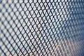 Metal grid with numerous small cells on light background Royalty Free Stock Photo