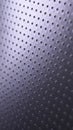 Dark metallic mobile wallpaper. Perforated aluminum surface with many holes. Tinted violet or purple tech background. Vertical