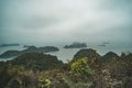 A dark and misty overcast morning on Halong Bay, toned photo. Beautiful mountain landscape with the viewpoint on the island of Cat Royalty Free Stock Photo