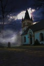 Dark Misty Spooky image of an old Swedish cemetery with its church Royalty Free Stock Photo