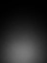 A dark and moody abstract gradient background with a subtle spotlight effect in the lower center transitioning to black at the and Royalty Free Stock Photo