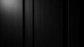 Dark moody background of vertical black wood grain texture with subtle light Royalty Free Stock Photo