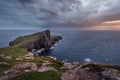 Dark and moody storm clouds over Neist Point lighthouse on the Isle of Skye. Royalty Free Stock Photo