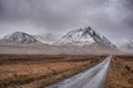 Dark and moody Winter landscape image of Lost Valley Etive Mor in Scottish Highlands wirth dramatic clouds overhead Royalty Free Stock Photo