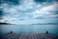 Dark morning by the sea. Pier in storm. Solitude, Loneliness concept photo Royalty Free Stock Photo