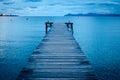 Dark morning by the sea. Pier in storm. Solitude, Loneliness concept photo Royalty Free Stock Photo