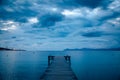Dark morning by the sea. Pier in storm. Solitude, Loneliness concept photo Royalty Free Stock Photo