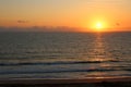 Dark Morning Sunrise on Ocean with Sun Reflecting on Water