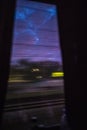 Night train window view on a movement dark urban landscape Royalty Free Stock Photo