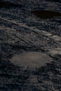 Dark muddy road background with tire traces, dirty ground