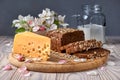 Dark multigrain bread made from rye, wheat, oats and barley with sunflower and flax seeds. Milk, cheese, apple tree flowers and Royalty Free Stock Photo